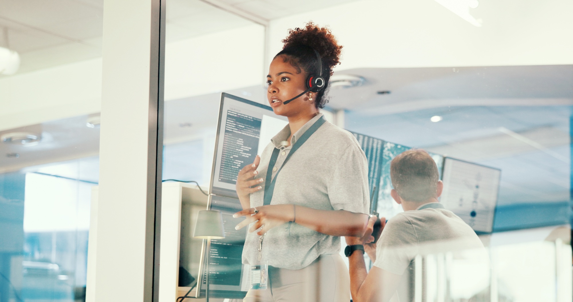 Concern, control room and headset with woman in airport for communication, safety or weather update