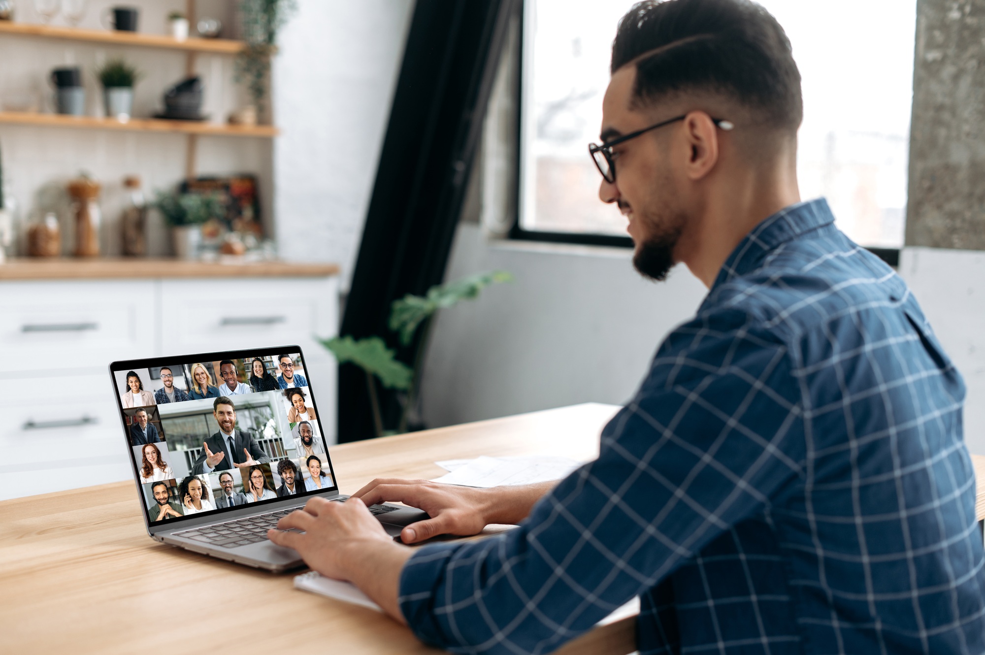 Smart indian or arabian guy meet with a group of multiracial colleagues gathered in a video
